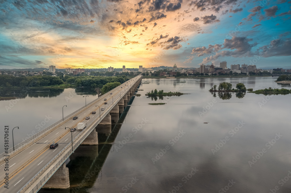 Aerial view of George Wade Memorial Bridge over the Susquehanna River overlooking Harrisburg capital city of Pennsylvania with dramatic colorful sunset sky