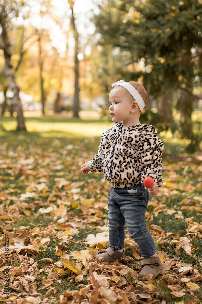 Happy little girl in the autumn park, laughs. Happy autumn Happy little girl in the autumn park, laughs. Happy autumn