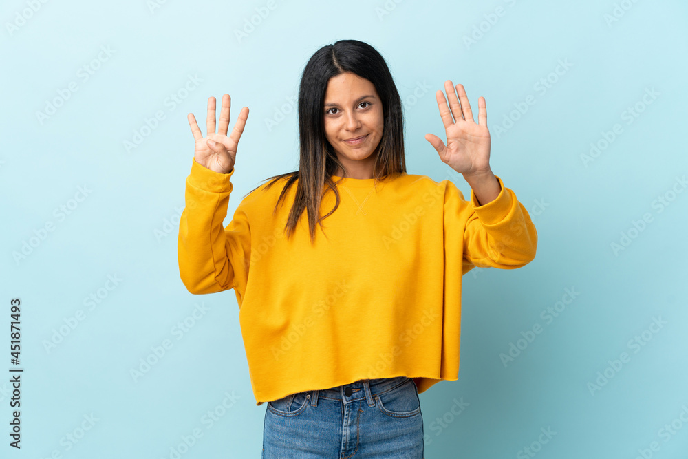 Caucasian girl isolated on blue background counting nine with fingers Caucasian girl isolated on blue background counting nine with fingers