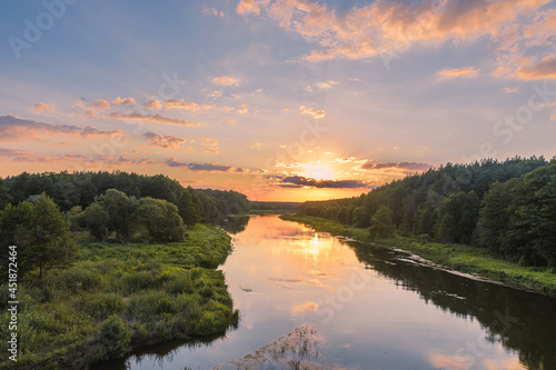 The view of the Viliya river in the forest. The sunset over the river. Nature landscape in Belarus