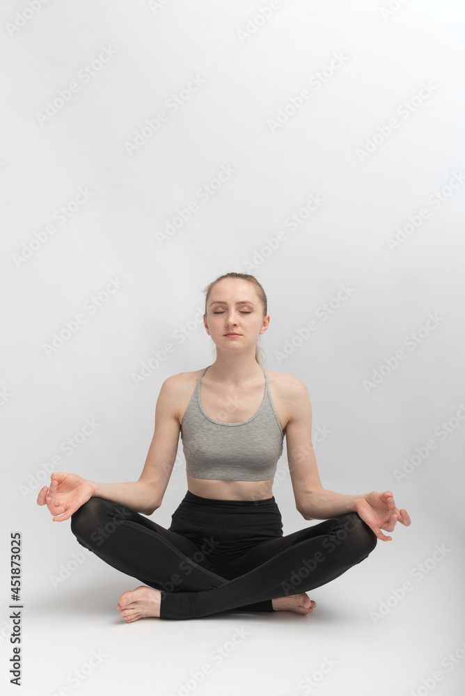 Sukhasana. Easy Pose. Young slender woman does yoga and meditates. Girl practices pranayama. Sukhasana. Easy Pose. Young slender woman does yoga and meditates. Girl practices pranayama.