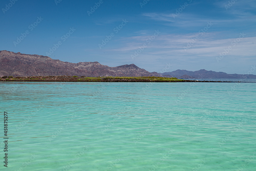Seascape of baja California Sur. Loreto Mexico with mountains blue sea and white sand beach