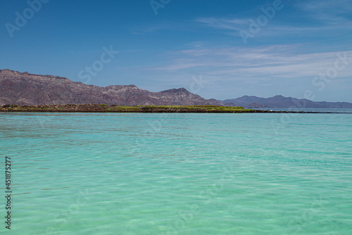 Seascape of baja California Sur. Loreto Mexico with mountains blue sea and white sand beach