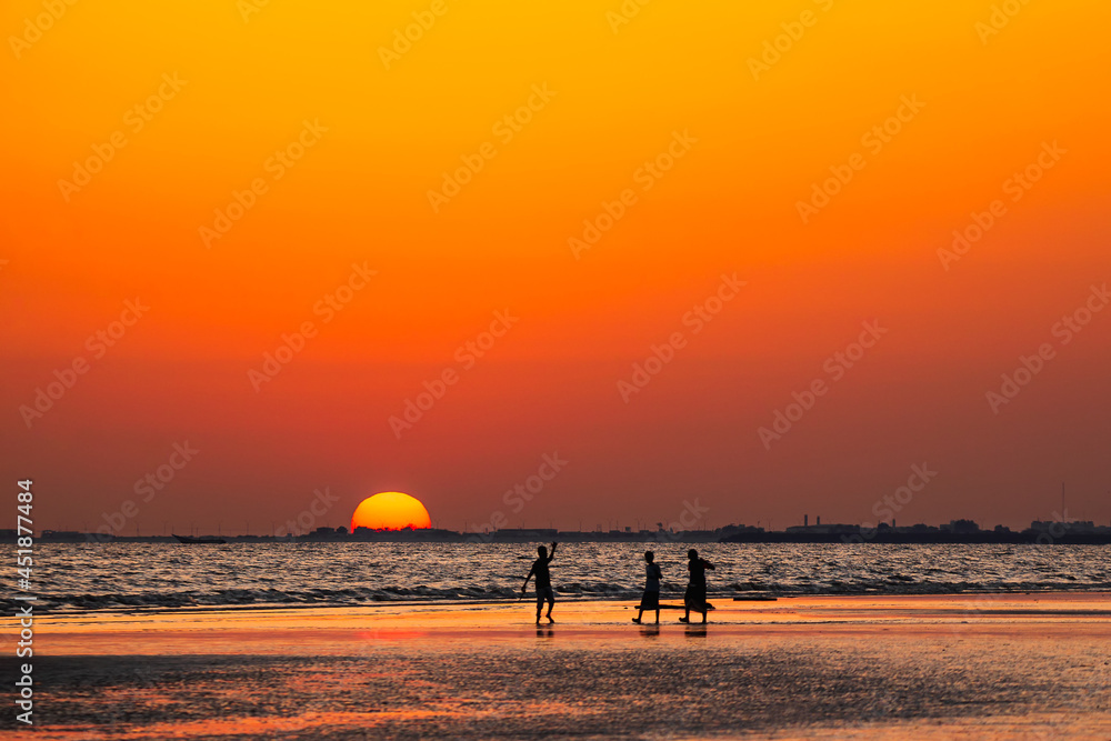 Silhouette of kids playing at beach with sunset background. Yemen nature. Yemen landscape.