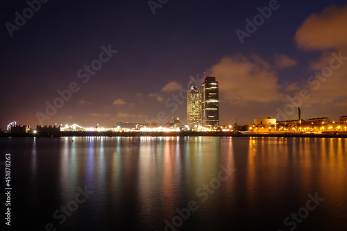 Barcelona, ​​views of the city, the sea and the mapfre tower. Skyscrapers of the Paseo Maritimo illuminated at night in Barcelona, ​​Catalonia, Spain photo