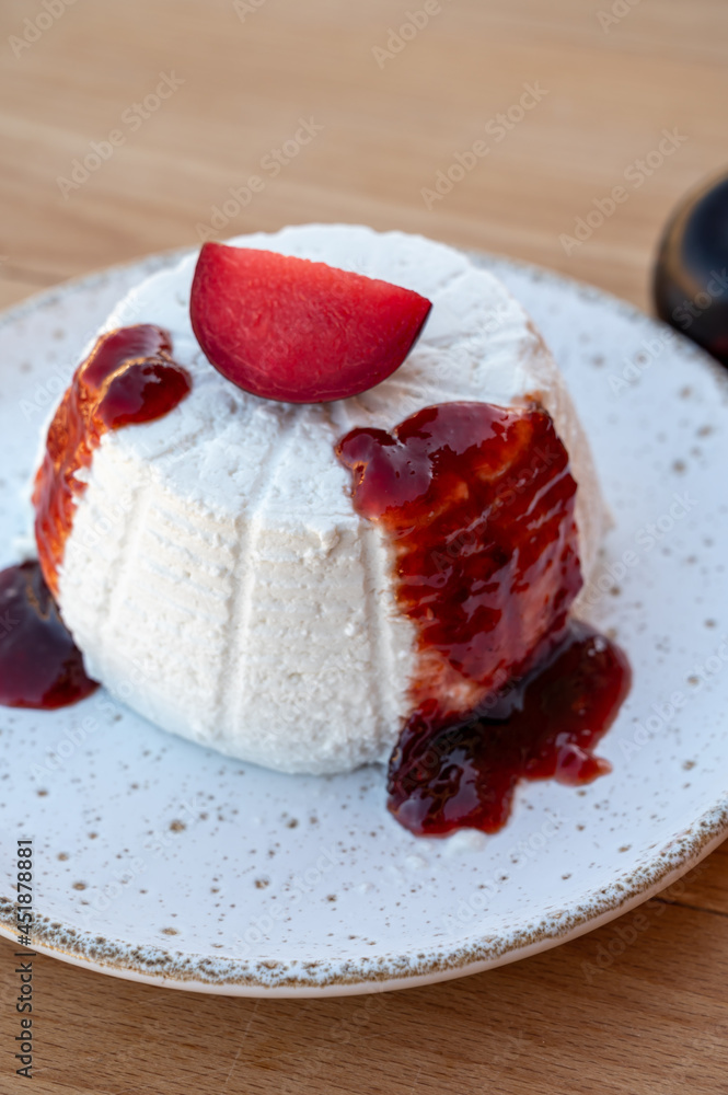 Cheese collection, white Italian soft cheese ricotta served as sweet dessert with homemade plum jam Cheese collection, white Italian soft cheese ricotta served as sweet dessert with homemade plum jam