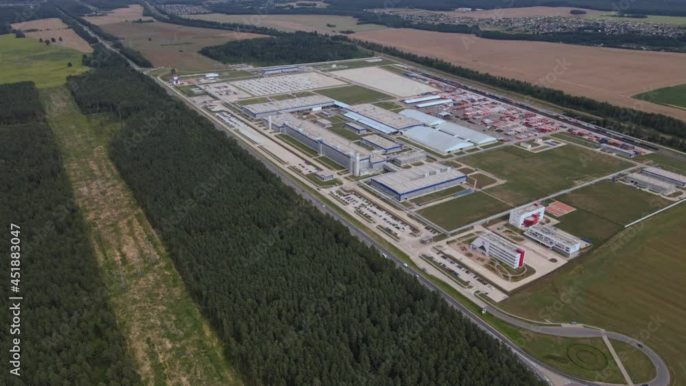 Aerial view of modern factory. Industrial territory and many cars nearby from above. Industrial concept. Aerial view of modern factory. Industrial territory and many cars nearby from above. Industrial concept.