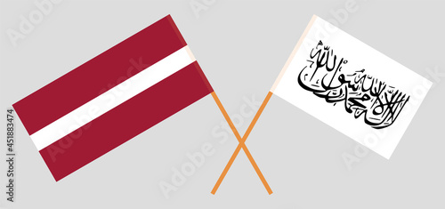 Crossed flags of Latvia and Islamic Emirate of Afghanistan. Official colors. Correct proportion photo
