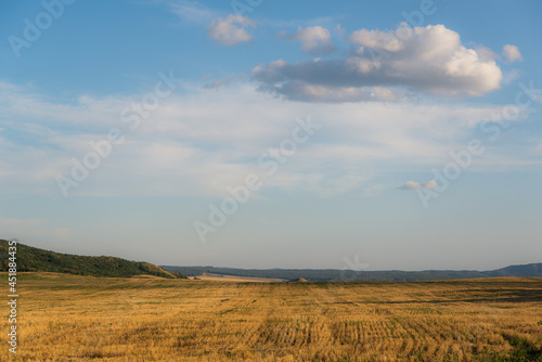 Beveled yellow field and clouds.