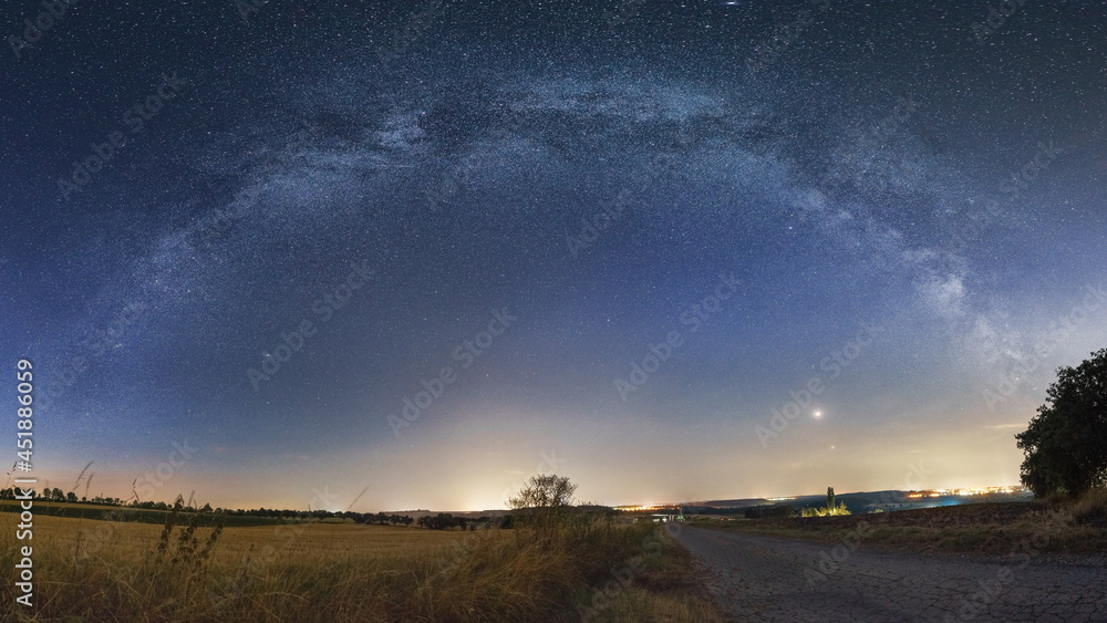 Panorama the Total Moon Eclipse, Mars Opposition and Milky Way bow over rural landscape in Eifel on July 27, 2018, Germany