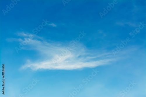 The blue sky is tinged with white clouds in the air on a bright summer day.