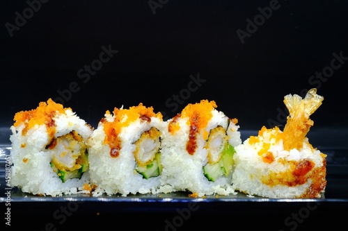 4 pieces of sushi shrimp tempura rolls served on plate