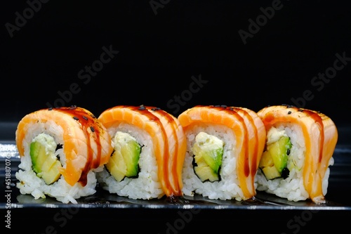 4 pieces of sushi rolls with salmon and avocado