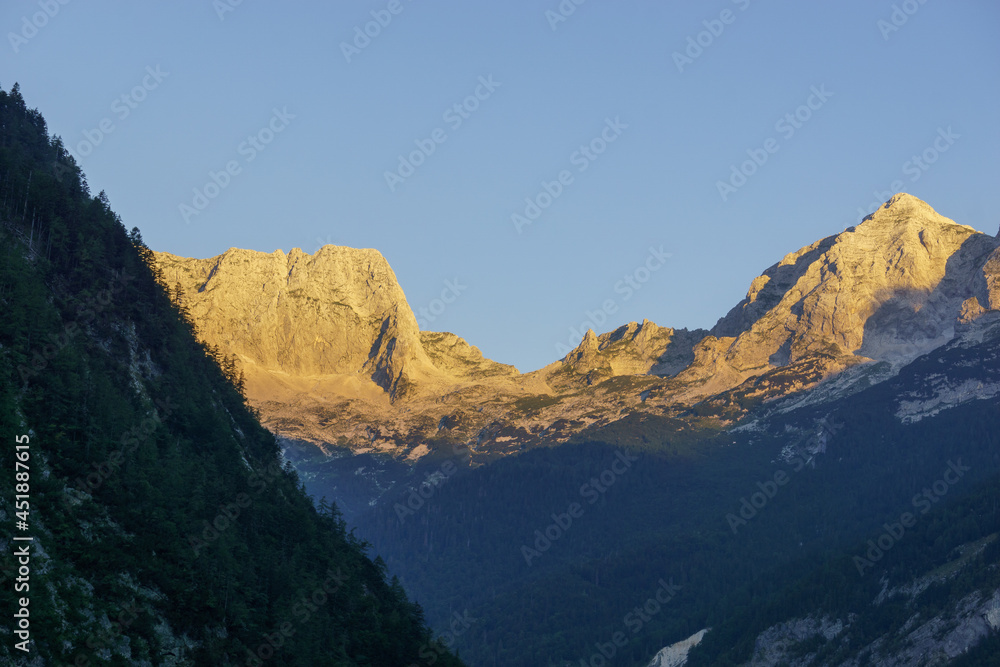 golden color of mountain peaks at sunrise in triglav nationalpark, slovenia golden color of mountain peaks at sunrise in triglav nationalpark, slovenia