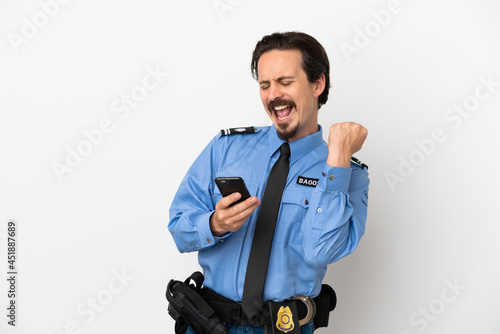 Young police man over isolated background white with phone in victory position