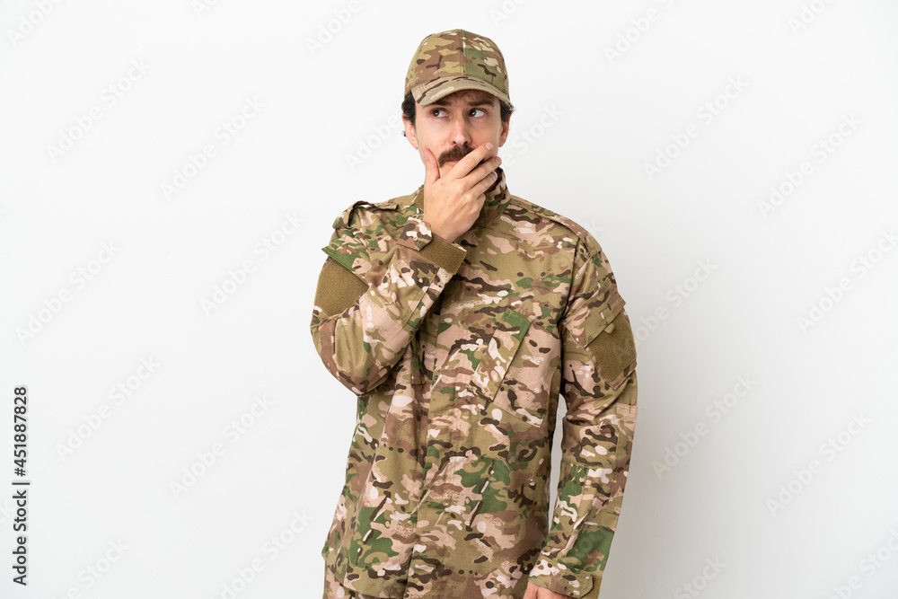 Soldier man isolated on white background having doubts and with confuse face expression Soldier man isolated on white background having doubts and with confuse face expression