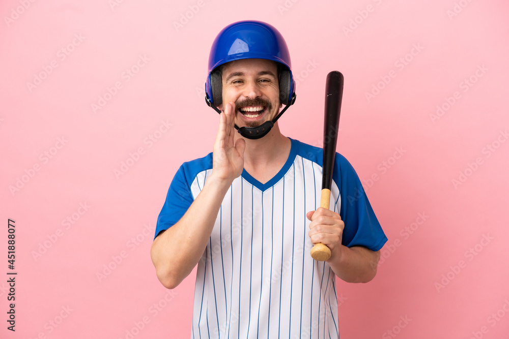 Young caucasian man playing baseball isolated on pink background shouting with mouth wide open Young caucasian man playing baseball isolated on pink background shouting with mouth wide open