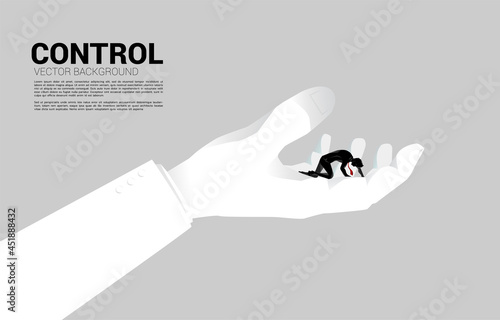 silhouette of businessman on knee in big hand. Concept for work life in control.