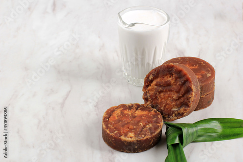 Gula Malacca or Coconut Palm Sugar, Popular as Brown Sugar (Gula Merah) with Coconut Milk and Pandan Leaf, Ingredients Aromatic Making Indonesian or Malaysian Traditional Cake. Isolated on White 