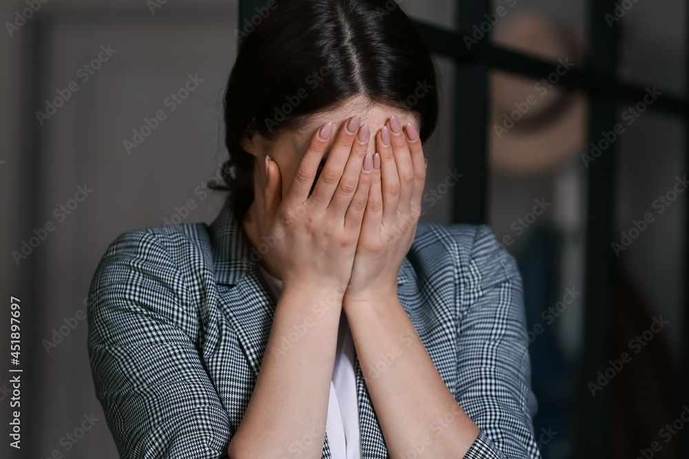 Young depressed businesswoman in dark office Young depressed businesswoman in dark office
