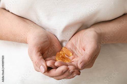 Mature woman with fish oil, closeup