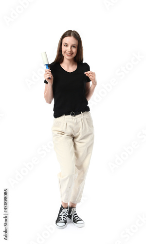 Young woman with lint rolle...