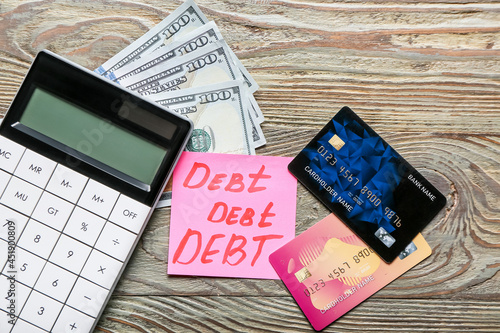 Paper with word DEBT, money...