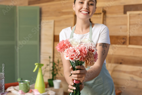 Female florist with carnati...
