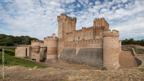 Panoramic view of the castle of La Mota, Spain, with its towers, outer wall and moat.
