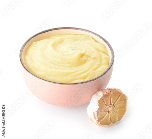 Bowl of tasty mashed potatoes with garlic on white background