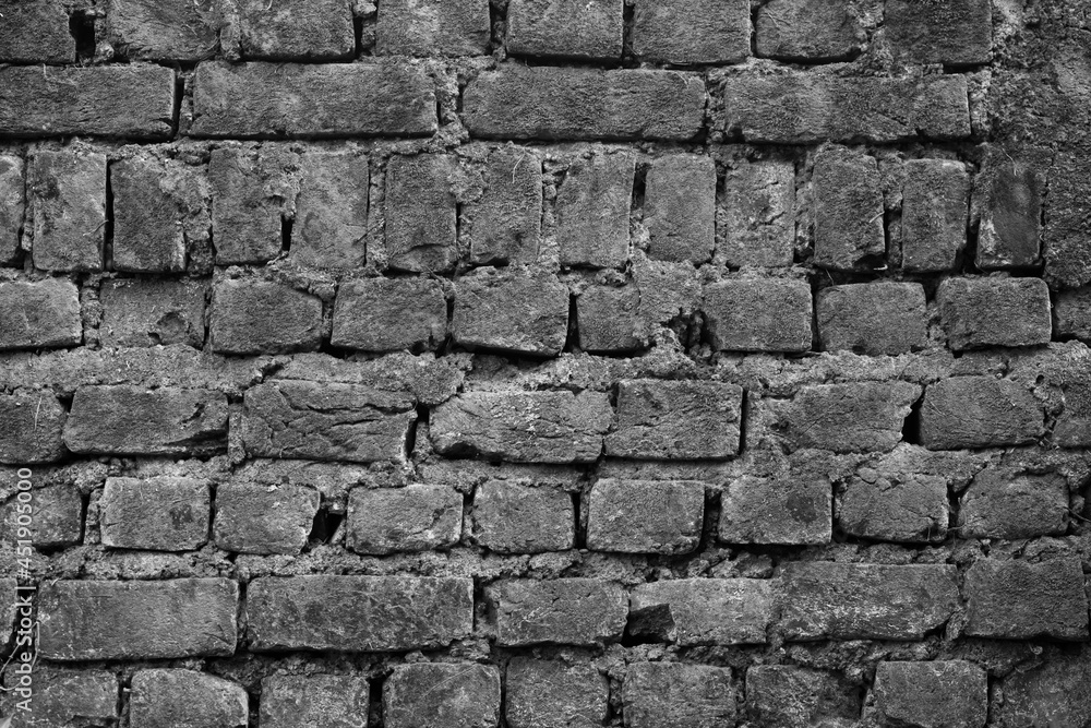 Fototapeta premium An old brick wall with patters as an Abstract in black and white