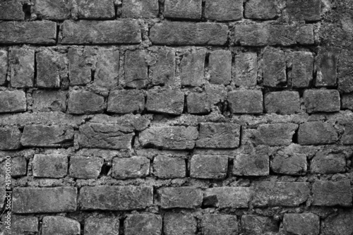 An old brick wall with patters as an Abstract in black and white 
