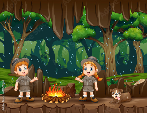 Two safari kids light a bonfire in the cave