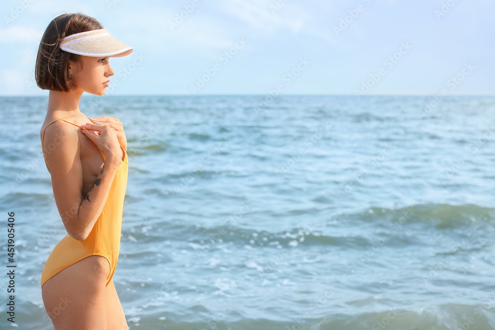 Beautiful young woman on sea beach