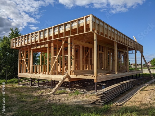 construction of a timber frame house. frame of a private residential building with a window and without walls