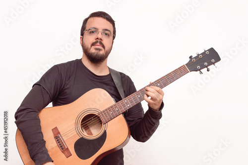 white adult Hispanic Latin male with beard and lens posing with an acoustic guitar on a white background