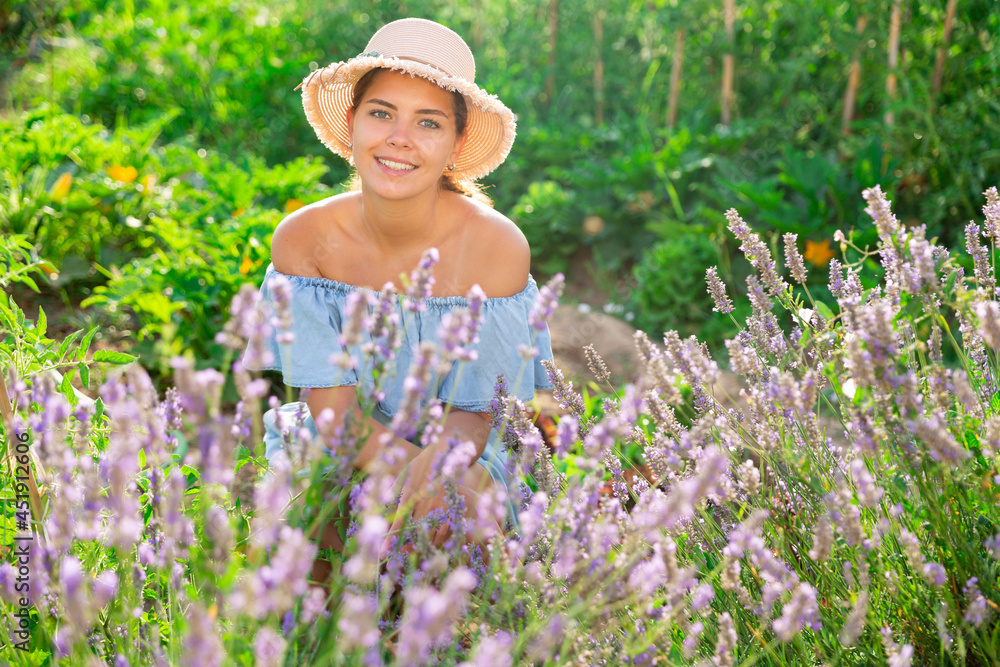 Portrait of lovely woman with basket on lavender field