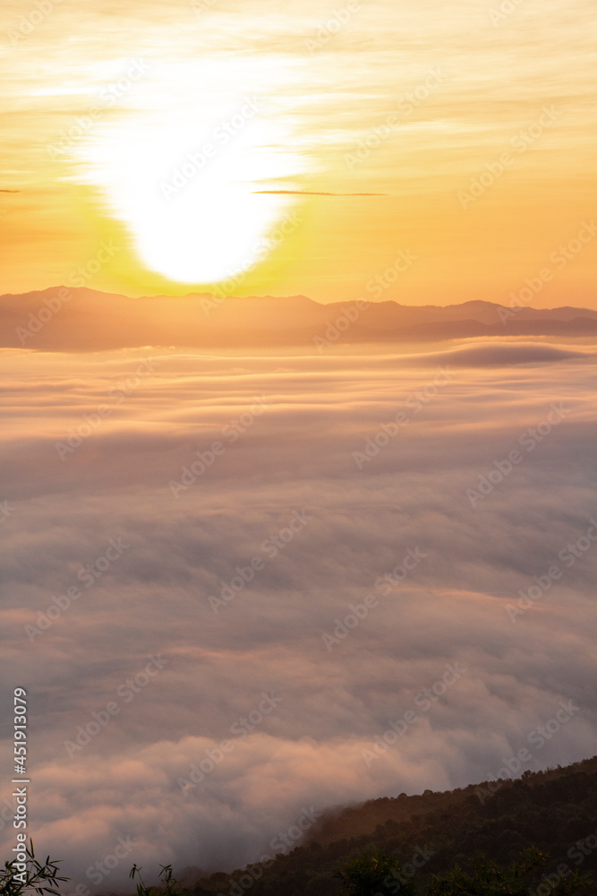 sunrise or sunset with mist and mountain. Orange sky.