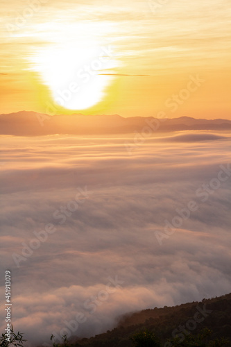 sunrise or sunset with mist and mountain. Orange sky. © Nimedly