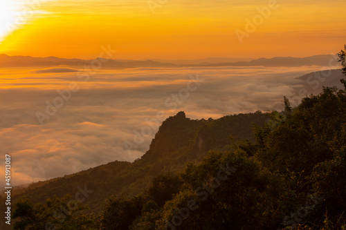 sunrise or sunset with mist and mountain. Orange sky.