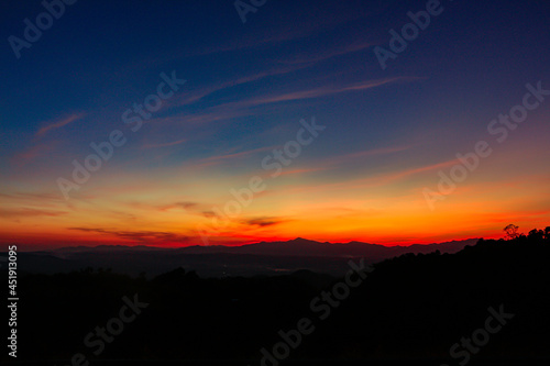 sunrise or sunset with mountain. Orange and blue sky background.