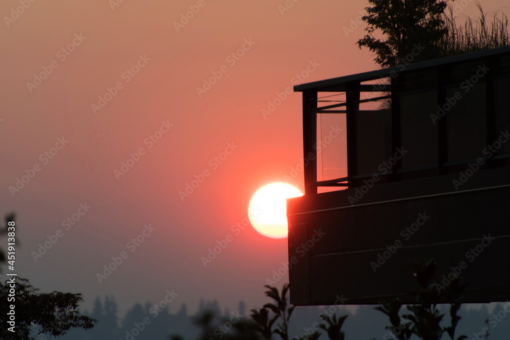 Glowing sun disk during sunset in the middle of wild fires season Glowing sun disk during sunset in the middle of wild fires season