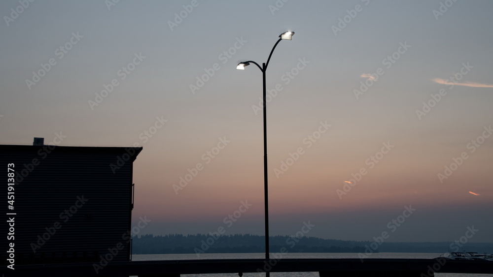 Street light and smoky sunset near marina in Kirkland Street light and smoky sunset near marina in Kirkland
