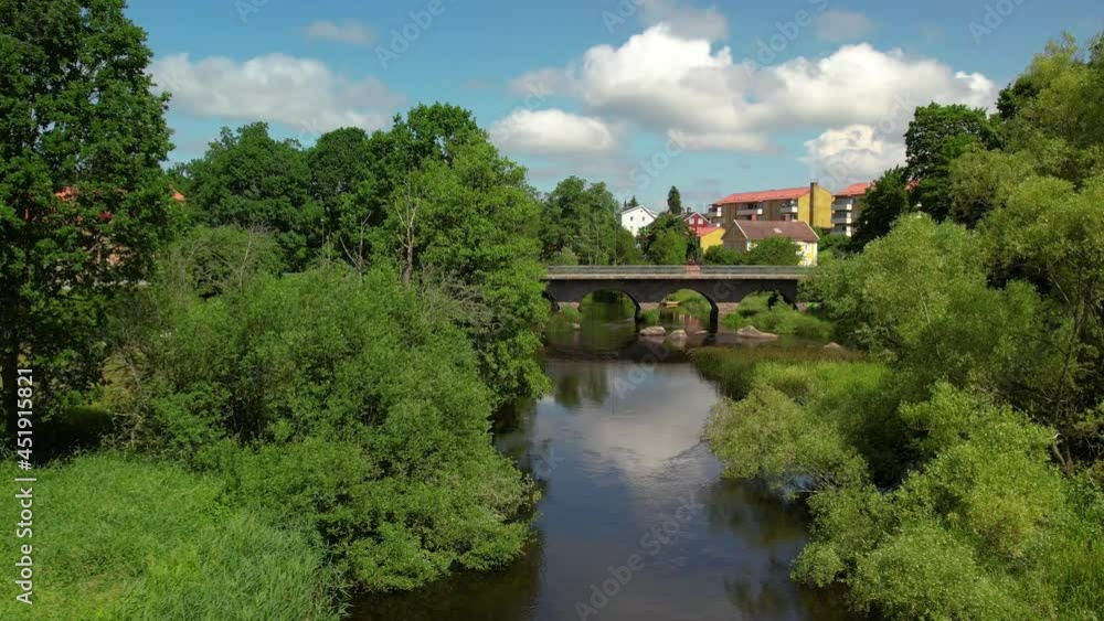 Drone flying towards bridge over river Emån in Högsby, Sweden. Church spotted Drone flying towards bridge over river Emån in Högsby, Sweden. Church spotted