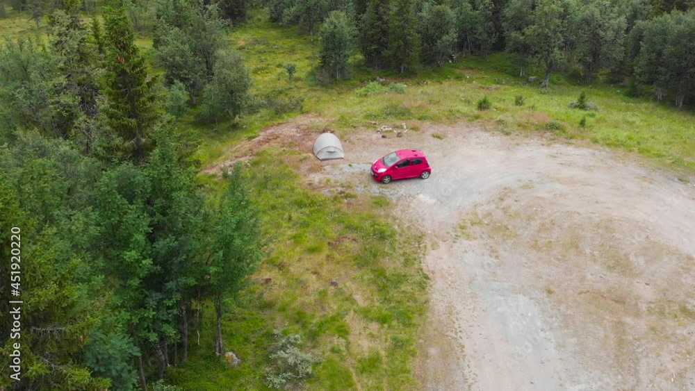 Red Car And A Tent In A Camping Ground With Vegetation In Sweden. aerial drone Red Car And A Tent In A Camping Ground With Vegetation In Sweden. aerial drone