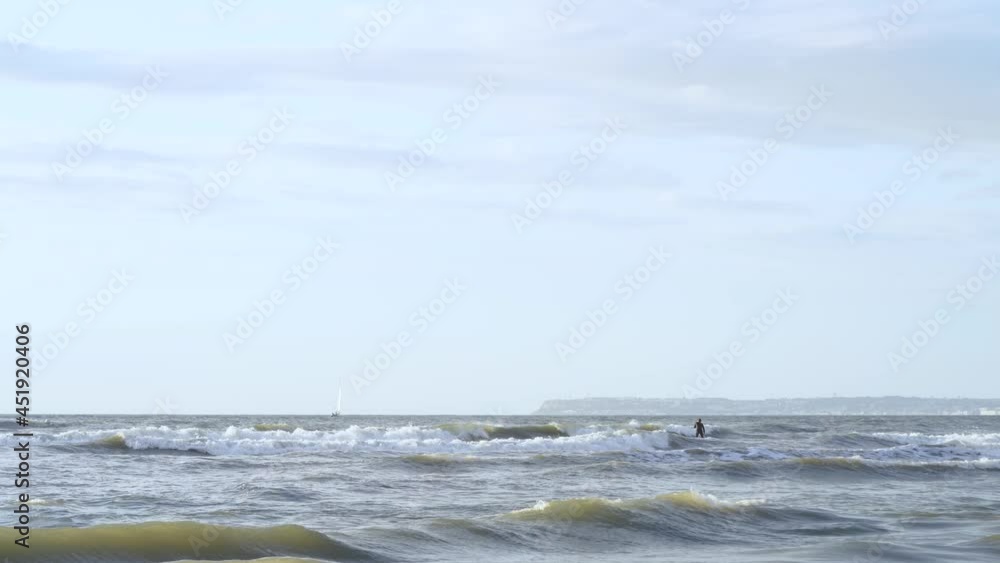 People Enjoying Surfing And Standup Paddle Boarding At The Beach On Summer In Deauville, France. - wide shot People Enjoying Surfing And Standup Paddle Boarding At The Beach On Summer In Deauville, France. - wide shot