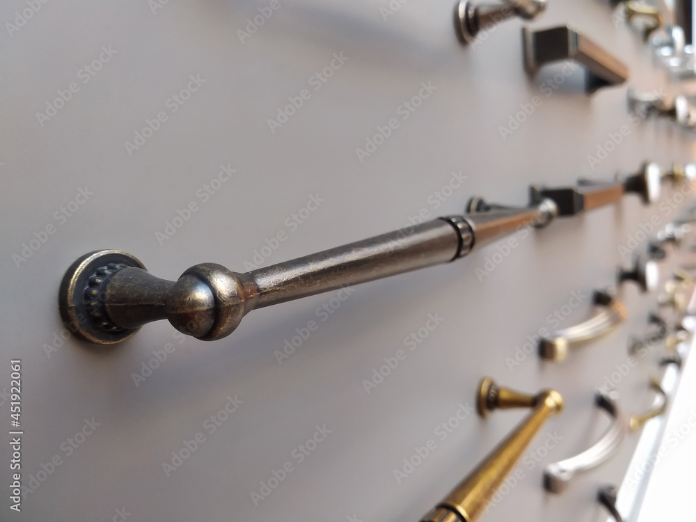 Furniture handle on a gray wall. Furniture fittings shop Furniture handle on a gray wall. Furniture fittings shop