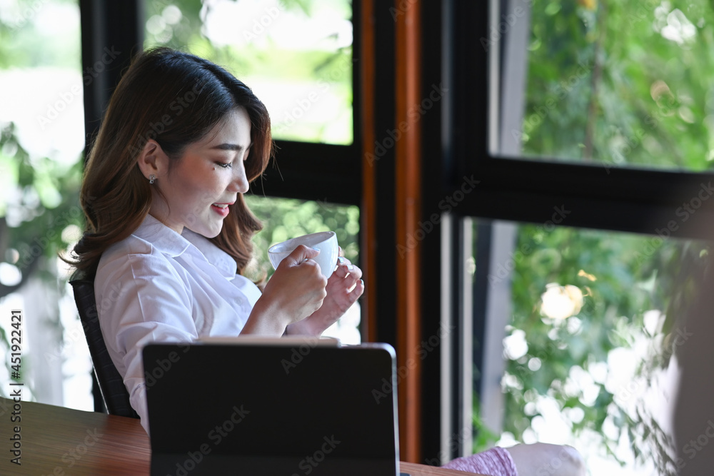 Businesswoman taking coffee break in modern office. Businesswoman taking coffee break in modern office.
