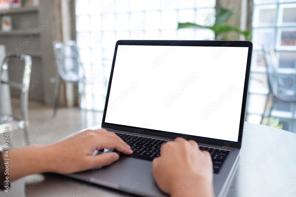 Mockup image of a woman using and typing on laptop computer with blank white desktop screen Mockup image of a woman using and typing on laptop computer with blank white desktop screen
