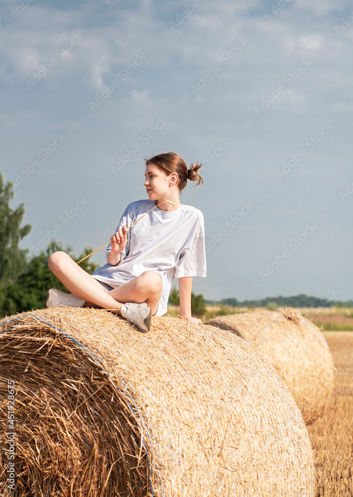 Teenager girl having fun in a wheat field on a summer day. Teenager girl having fun in a wheat field on a summer day.